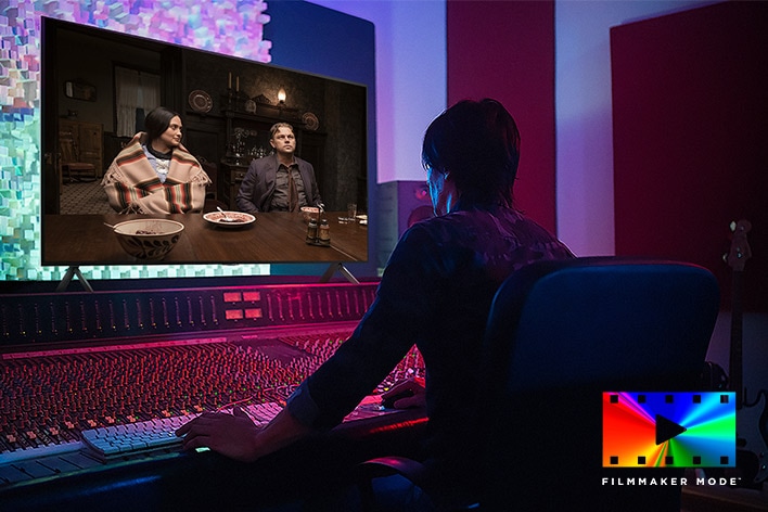 A director in front of a control panel editing the movie "Killers of the Flower Moon" on an LG QNED TV. In the bottom right, FILMMAKER MODE logo.