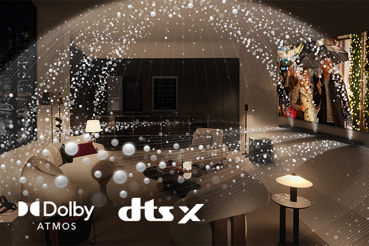 A movie plays on an LG OLED TV and LG Soundbar in a modern city apartment in a side angle view. White beads depicting sound waves project upwards and downwards from the Soundbar and TV, creating a dome of sound in the space. Dolby Atmos logo DTS X logo