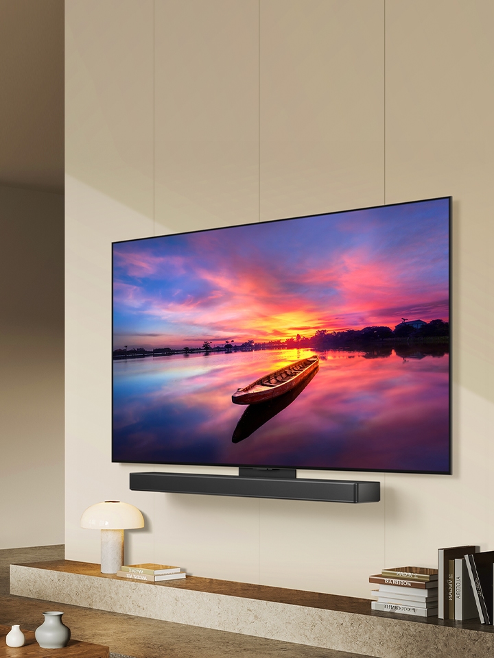 The LG ultra slim designed OLED evo C4 facing 45 degrees to the left displaying a beautiful sunset with Soundbar via the Synergy bracket.