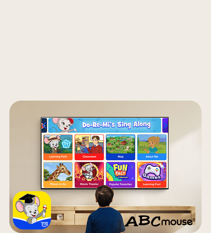 A little boy sits on the floor and watches educational content on ABCmouse.