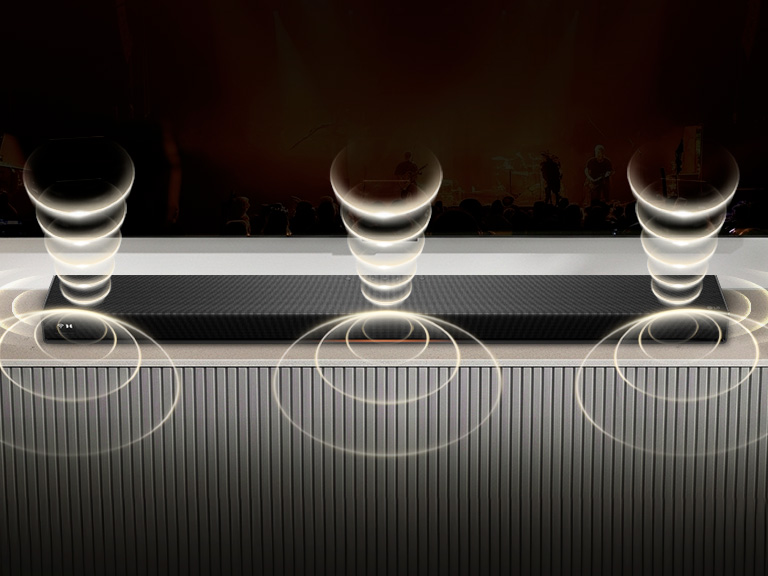 1) LG Sound Suite placed in a living room, demonstrating flexible speaker placement for an immersive home sound system 2) LG Sound Suite with Dolby Atmos FlexConnect technology detects each speaker’s location to optimize surround sound systems 3) Close-up of the LG Sound Suite W7 woofer with its driver showing deep bass performance down to 29.5 Hz