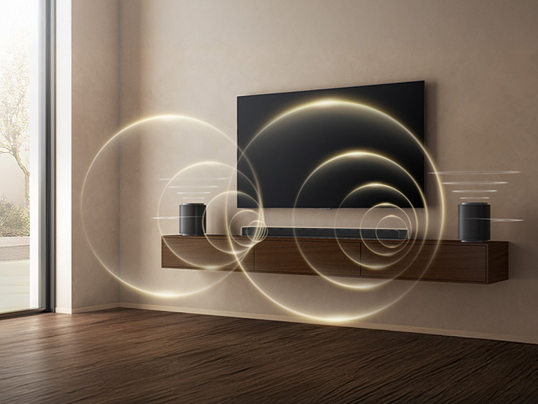 ' LG Sound Suite pair of speakers and soundbar placed with a TV, delivering rich surround sound system for TV with full Dolby Atmos