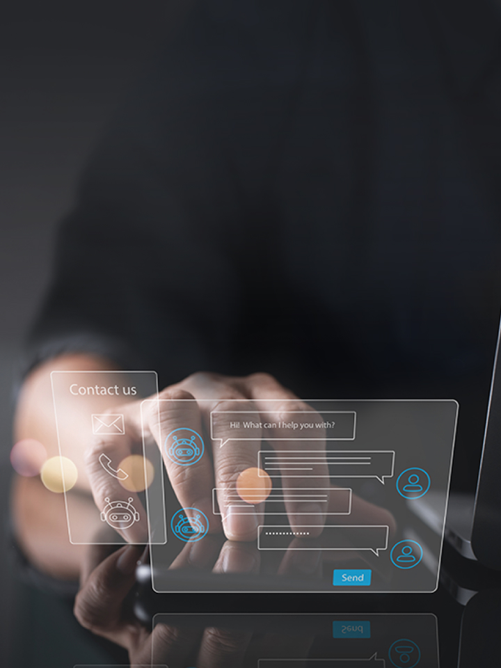 Two virtual hologram windows which are chatting and contact us float next to the laptop and hands are placed behind them.