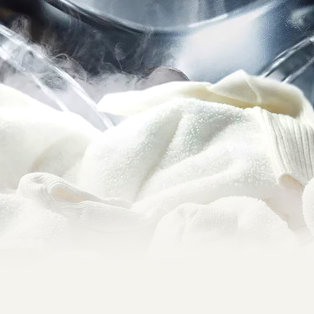 Close-up of soft white laundry with visible steam inside an LG drum illustrates steam technology for gentle fabric care and freshness.