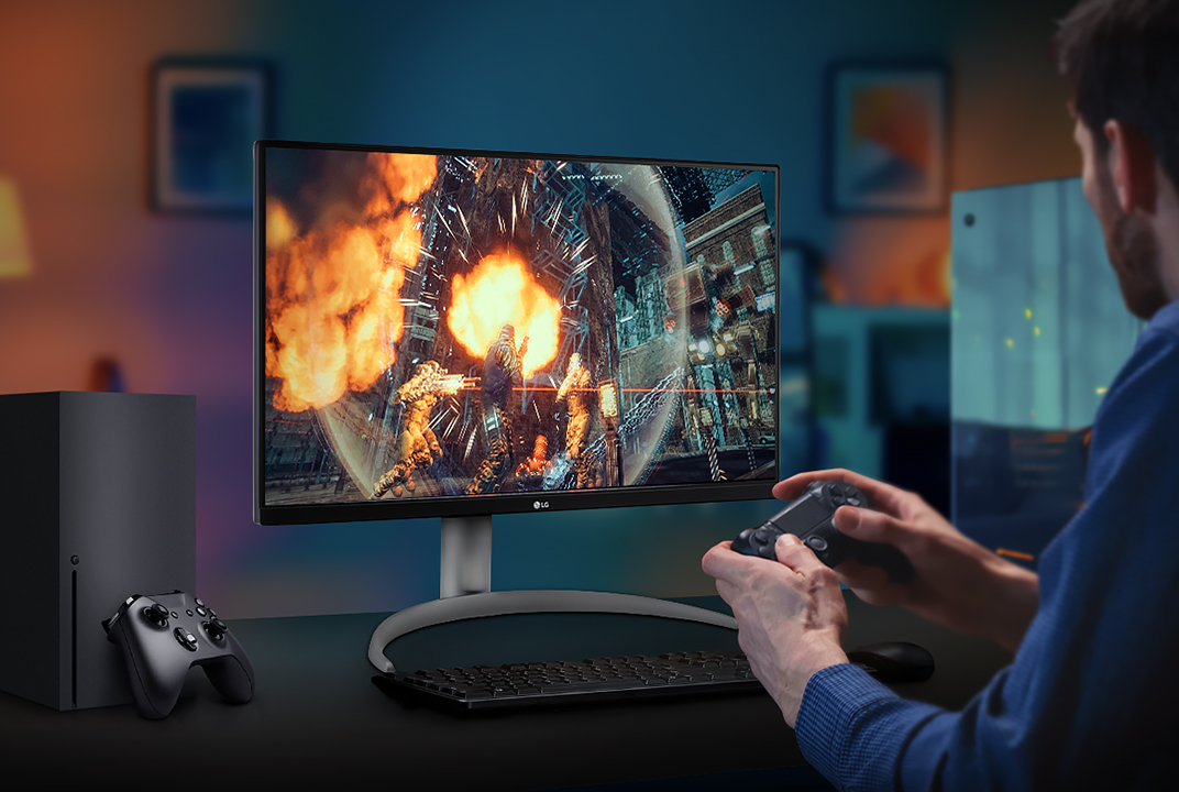 LG gaming monitor showing an action game with a player holding a controller illustrates VRR for smoother motion during gameplay.