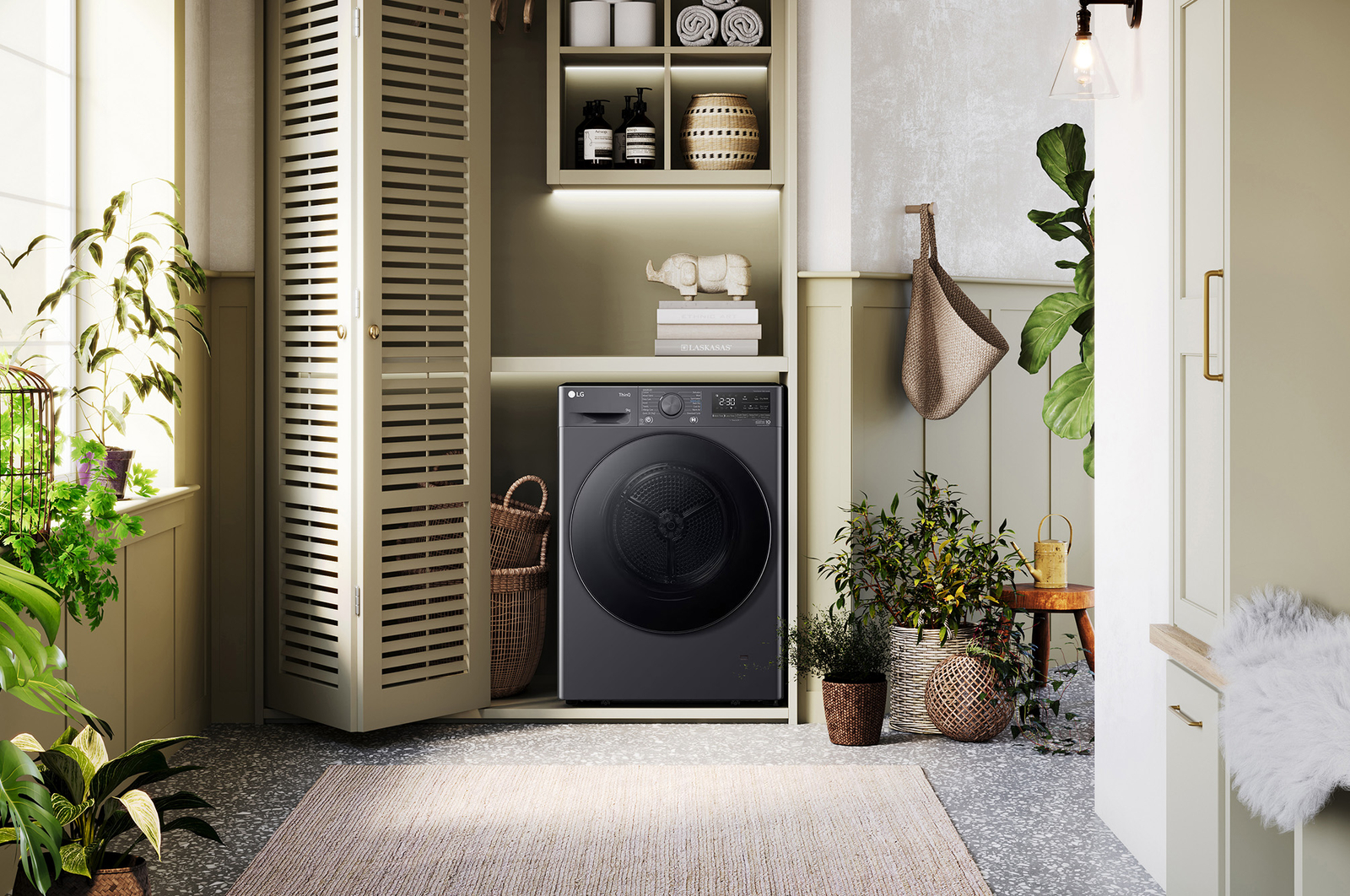 The LG 9kg dryer FDV709GN in Slate Grey, shown installed in a stylish, modern laundry closet.
