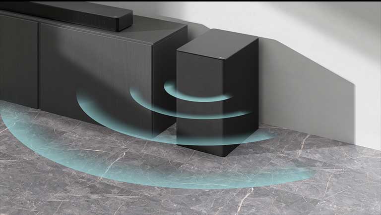 A Soundbar is placed on the cabinet. Beside a wireless subwoofer placed on the floor. Blue sound graphics are coming out from the subwoofer.