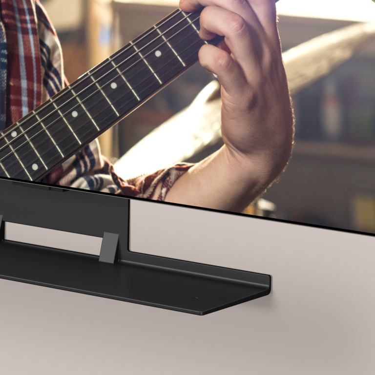 A video opens showing an angled view of the bottom of an LG OLED TV and Synergy bracket. The LG Soundbar slots into the Synergy Bracket.