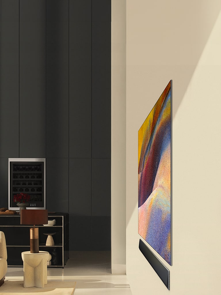 The LG OLED G4 displays an abstract artwork while the LG Soundbar sits flat against the wall in a modern living space without any gap, showcasing its one-wall design. 