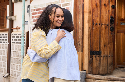 The host hugs the guest as they say goodbye.