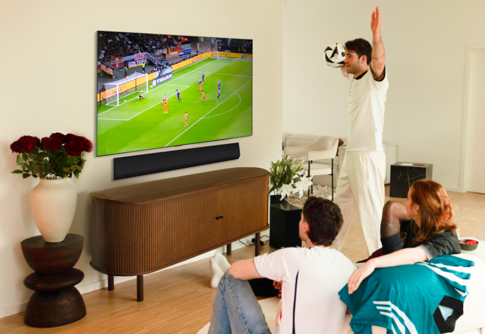 Janis Danner cheers while watching a football game with friends on her LG OLED G4 TV.