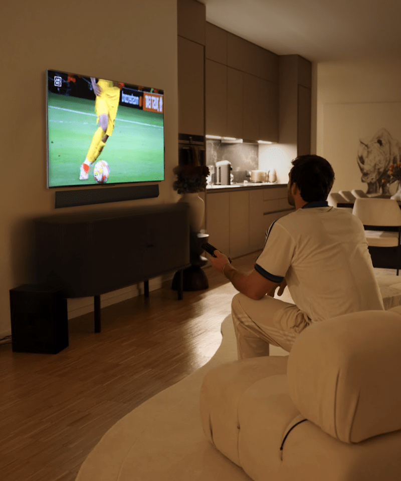 Janis Danner is watching football game highlights on LG OLED G4 TV at night.