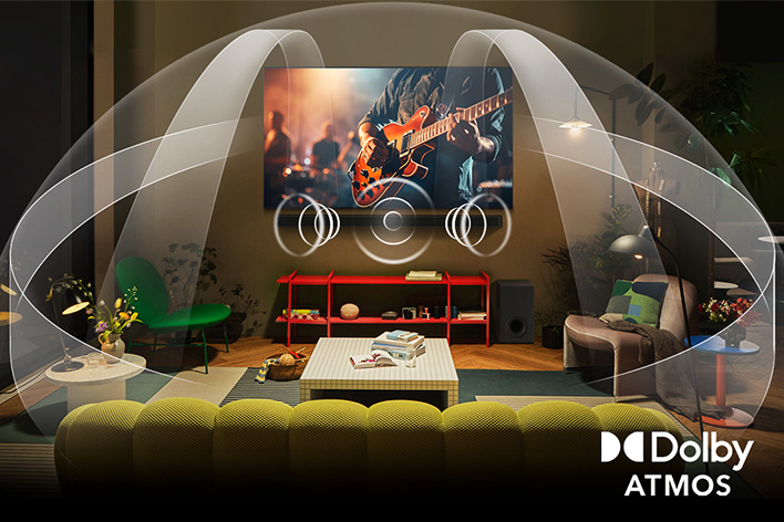Dimly lit, cozy living room with a couple watching a movie on their LG OLED TV with LG Soundbar. Graphics show how Dolby Atmos fills the whole space with surround sound from all directions. Dolby Atmos logo is at the bottom corner.	