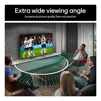 Living room space with a wall-mounted LG OLED TV. On the TV is a mountain range against a dark evening sky filled with stars. This scene is split in half. One side shows a duller, grayer version of the landscape labeled, Non Perfect Black display. On the other side is a more pleasing picture with a larger dynamic range of blacks and whites. 