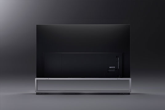 Image of the LG SIGNATURE OLED 8K taken from behind. The image shows the back of the TV, including the base and connectivity ports, against a dark backdrop.