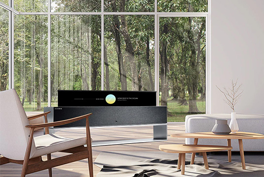 A wide view of the living room with LG SIGNATURE Rollable OLED TV in line view.