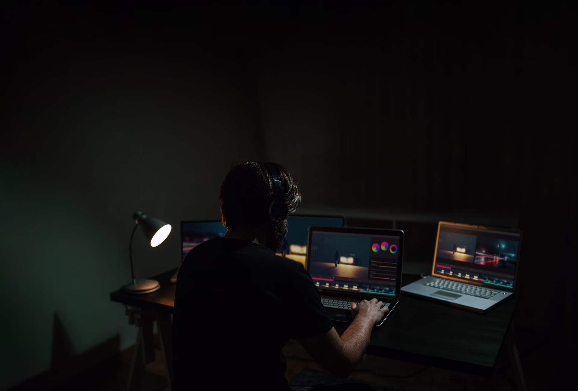 A man edits a movie while looking at the software on a computer monitor
