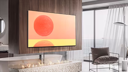 LG OLED G2 is hung on the wall in a brown and white room with red accessories